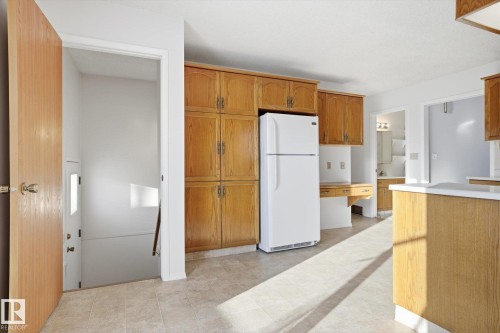 Kitchen with freestanding refrigerator, wood finish cabinets, and light countertops - 17816 94 Street, Edmonton, AB - Indoor Photo Showing Kitchen