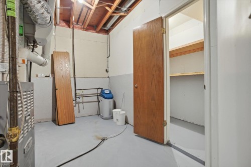 Unfinished basement with a water softener system and heating unit - 17816 94 Street, Edmonton, AB - Indoor Photo Showing Basement