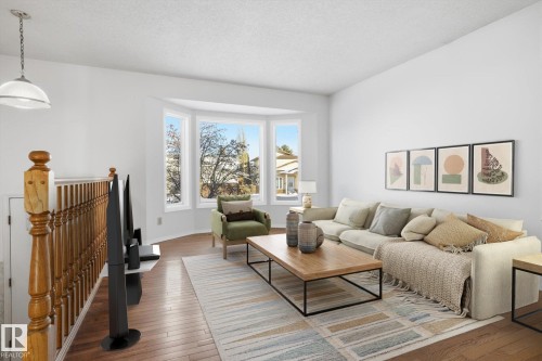 Living room with hardwood / wood-style floors and a textured ceiling - 17816 94 Street, Edmonton, AB - Indoor Photo Showing Living Room
