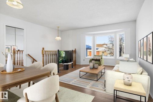Living area featuring hardwood / wood-style flooring and a textured ceiling - 17816 94 Street, Edmonton, AB - Indoor Photo Showing Living Room
