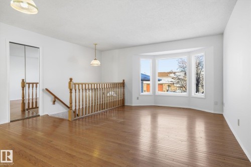 Unfurnished room with hardwood / wood-style floors and a textured ceiling - 17816 94 Street, Edmonton, AB - Indoor Photo Showing Other Room