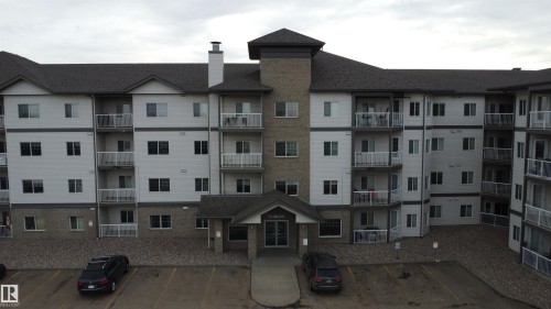 View of apartment building / complex with uncovered parking - 227 16807 100 Avenue, Edmonton, AB - Outdoor With Facade