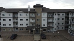 View of apartment building / complex with uncovered parking - 