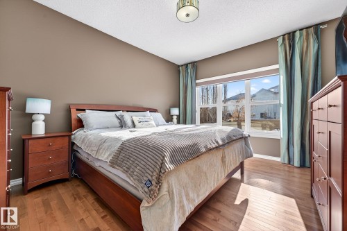 Bedroom with light wood-type flooring and a textured ceiling - 2036 Hilliard Place, Edmonton, AB - Indoor Photo Showing Bedroom