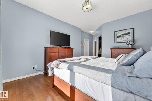 Bedroom with hardwood / wood-style flooring and ensuite bath - 2036 Hilliard Place, Edmonton, AB - Indoor Photo Showing Bedroom