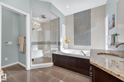 Full bathroom featuring vanity, a shower stall, and a bath - 