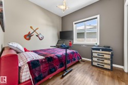Bedroom featuring wood-type flooring and baseboards - 