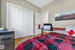 Bedroom featuring light wood-style flooring, a closet, and a textured ceiling - 