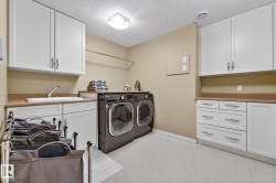 Laundry area with a textured ceiling, cabinet space, and washer and dryer - 
