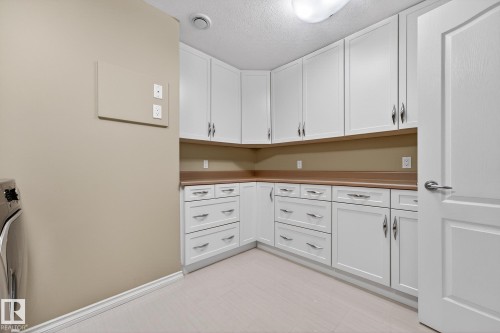 Laundry room with a textured ceiling and washer / clothes dryer - 2036 Hilliard Place, Edmonton, AB - Indoor