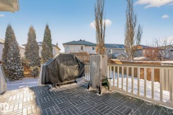 Wooden deck featuring a residential view and a grill - 