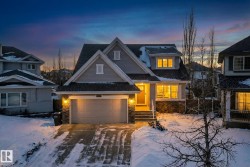 View of front of house with stone siding and driveway - 