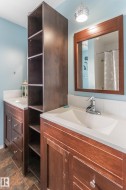 Bathroom with two vanities and a shower with shower curtain - 