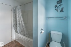 Full bathroom with shower / bath combo with shower curtain and dark stone finish flooring - 