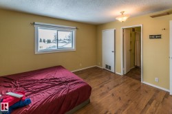Bedroom with dark wood finished floors and a textured ceiling - 