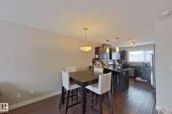 Dining space with dark wood-style flooring and a textured ceiling - 
