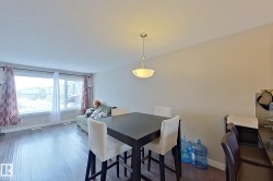 Dining space featuring dark wood-type flooring and a textured ceiling - 