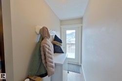 Entryway featuring washer / dryer and wood finished floors - 