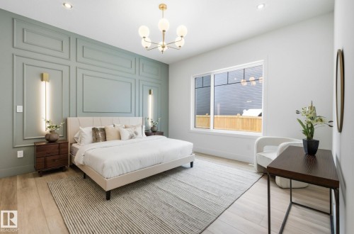 Bedroom featuring a decorative wall, light wood finished floors, a chandelier, and an accent wall - 296 165 Avenue, Edmonton, AB - Indoor Photo Showing Bedroom
