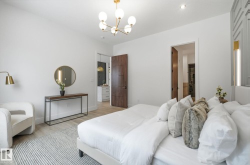 Bedroom with wood finished floors and suspended lighting - 296 165 Avenue, Edmonton, AB - Indoor Photo Showing Bedroom