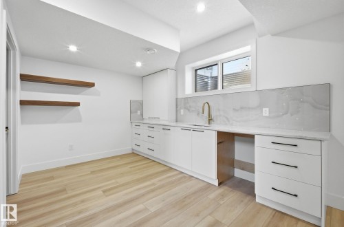 Kitchen featuring white cabinetry, modern cabinets, open shelves, light wood finished floors, and recessed lighting - 296 165 Avenue, Edmonton, AB - Indoor Photo Showing Kitchen