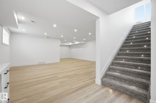 Below grade area with light wood-style floors and plenty of natural light - 296 165 Avenue, Edmonton, AB - Indoor Photo Showing Other Room