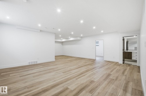 Finished below grade area featuring light wood-style flooring and recessed lighting - 296 165 Avenue, Edmonton, AB - Indoor