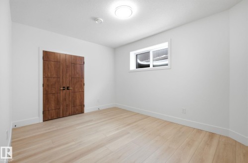 Unfurnished bedroom featuring light wood-style floors and a closet - 296 165 Avenue, Edmonton, AB - Indoor Photo Showing Other Room