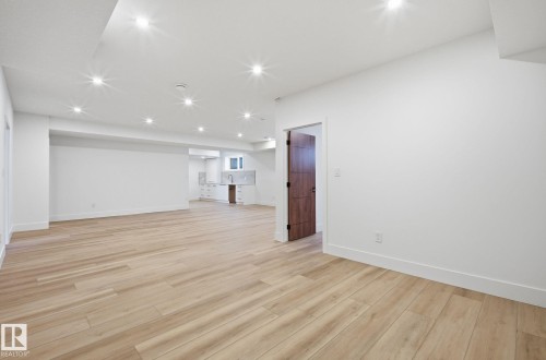 Finished below grade area featuring light wood-style flooring and recessed lighting - 296 165 Avenue, Edmonton, AB - Indoor Photo Showing Other Room