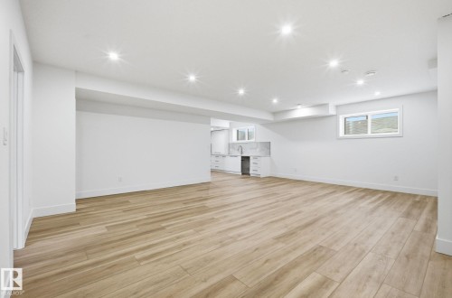 Unfurnished living room featuring light wood-style floors and recessed lighting - 296 165 Avenue, Edmonton, AB - Indoor