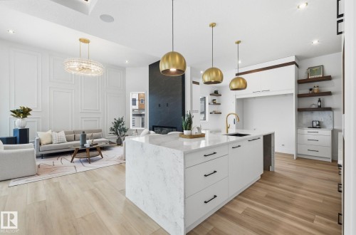 Kitchen with white cabinets, modern cabinets, open shelves, light wood-style flooring, and a decorative wall - 296 165 Avenue, Edmonton, AB - Indoor