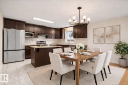 Dining space featuring a chandelier and baseboards - 