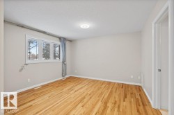 Unfurnished room featuring a textured ceiling and light wood finished floors - 