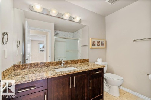 Full bath with vanity, a shower stall, and light tile patterned floors - 10639 70 Avenue, Edmonton, AB - Indoor Photo Showing Bathroom