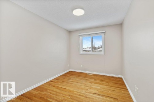 Spare room featuring light wood-style floors and a textured ceiling - 10639 70 Avenue, Edmonton, AB - Indoor Photo Showing Other Room
