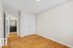 Unfurnished bedroom featuring light wood finished floors and a closet - 