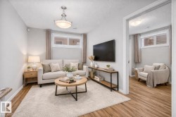 Living area featuring wood finished floors and a textured ceiling - 