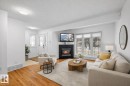 Living room featuring a textured ceiling, a tile fireplace, and wood finished floors - 10639 70 Avenue, Edmonton, AB  - Indoor Photo Showing Living Room With Fireplace 