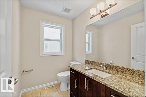 Half bathroom with light tile patterned floors and vanity - 10639 70 Avenue, Edmonton, AB - Indoor Photo Showing Bathroom