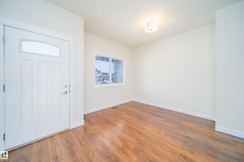 Foyer entrance with wood finished floors and baseboards - 19743 26 Avenue, Edmonton, AB - Indoor Photo Showing Other Room