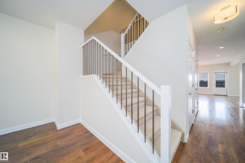 Stairway with hardwood / wood-style floors and baseboards - 19743 26 Avenue, Edmonton, AB - Indoor Photo Showing Other Room