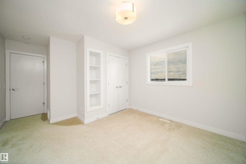 Unfurnished bedroom featuring light colored carpet and a closet - 19743 26 Avenue, Edmonton, AB - Indoor Photo Showing Other Room