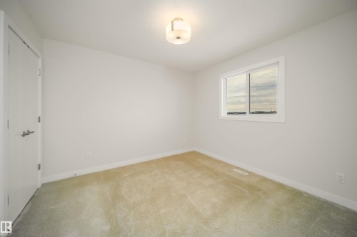Unfurnished bedroom with a closet and light carpet - 19743 26 Avenue, Edmonton, AB - Indoor Photo Showing Other Room