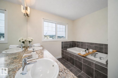Bathroom featuring double vanity and a garden tub - 19743 26 Avenue, Edmonton, AB - Indoor Photo Showing Bathroom