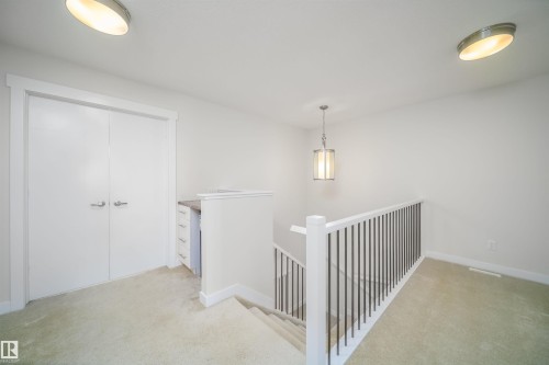 Corridor with an upstairs landing and light colored carpet - 19743 26 Avenue, Edmonton, AB - Indoor Photo Showing Other Room