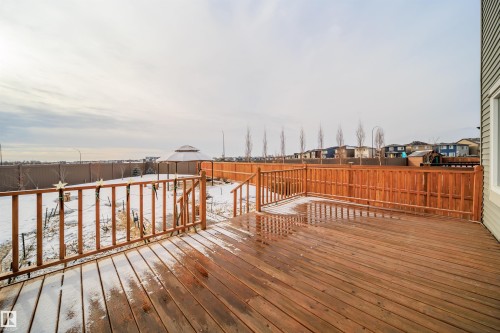 Snow covered deck with a fenced backyard, a residential view, and an outbuilding - 19743 26 Avenue, Edmonton, AB - Outdoor