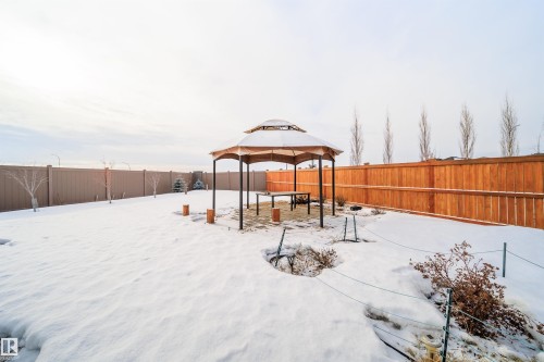 Snowy yard featuring a gazebo, a fenced backyard, and a patio area - 19743 26 Avenue, Edmonton, AB - Outdoor