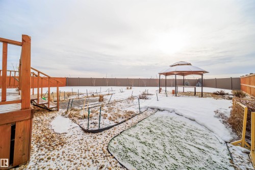 Snowy yard featuring a fenced backyard, a gazebo, and a wooden deck - 19743 26 Avenue, Edmonton, AB - Outdoor
