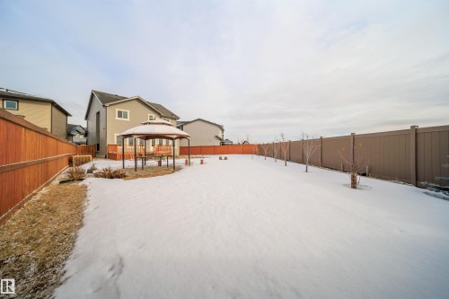 Yard layered in snow with a gazebo, a fenced backyard, and a patio - 19743 26 Avenue, Edmonton, AB - Outdoor