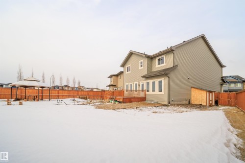 Snow covered house with a fenced backyard and a deck - 19743 26 Avenue, Edmonton, AB - Outdoor